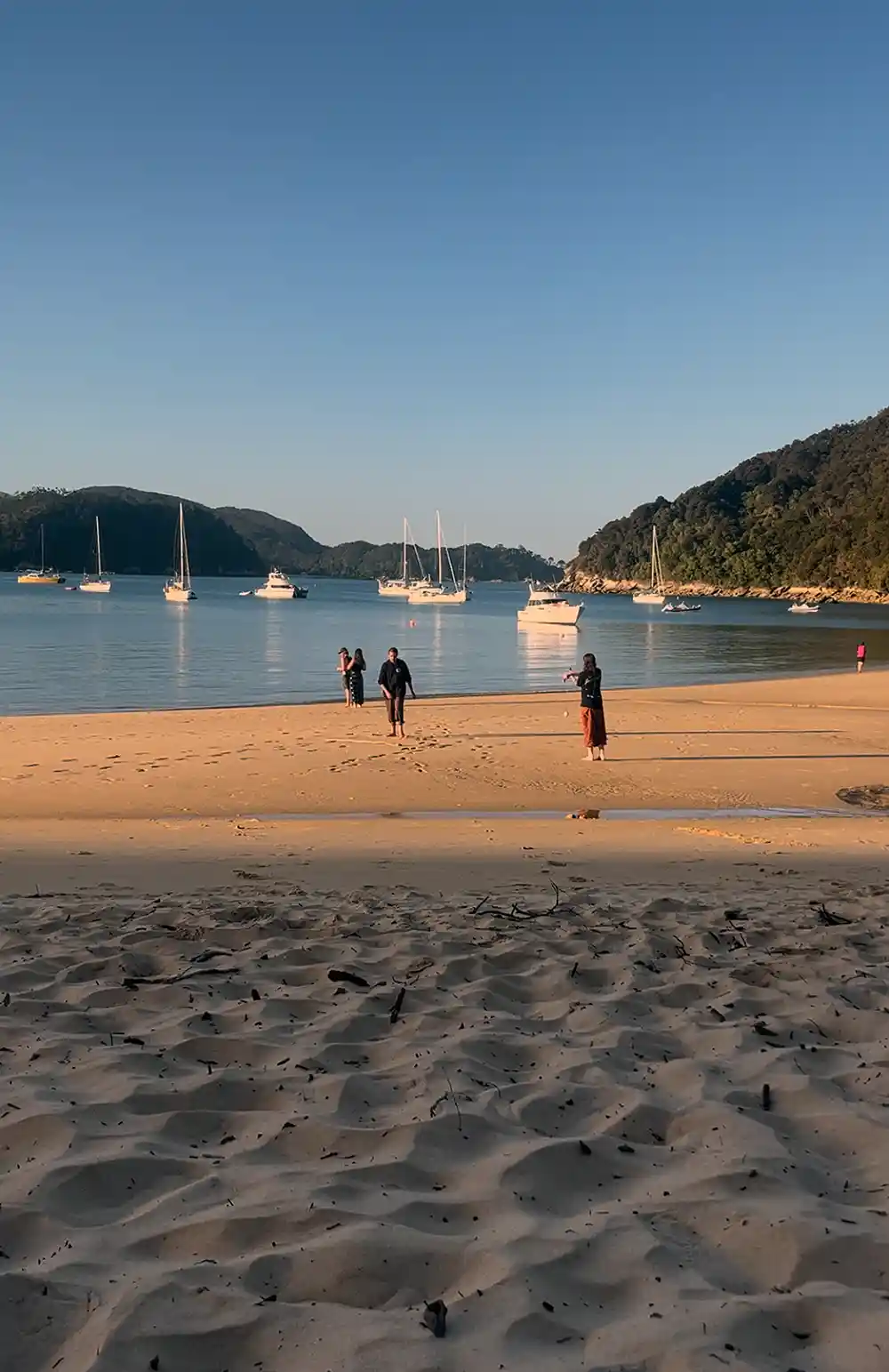 People enjoying the late afternoon sun on Achorage Beach