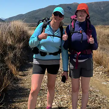 Two trampers on Gouland Downs, Heaphy Track giving a thumbs up