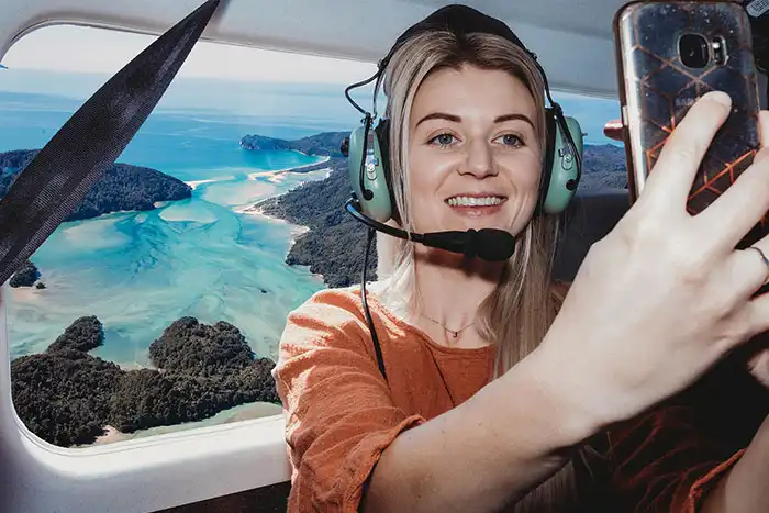 Selfie taken on Golden Bay Air scenic flight with view of Awaroa Inlet, Abel Tasman filling the window behind